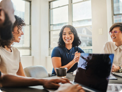 A person and another person looking at a computer