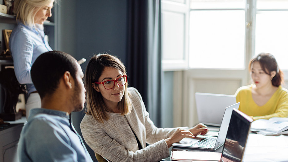 Colleagues in architect's office work on a project.