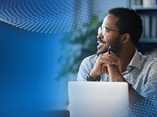A person sitting with a laptop and pen.