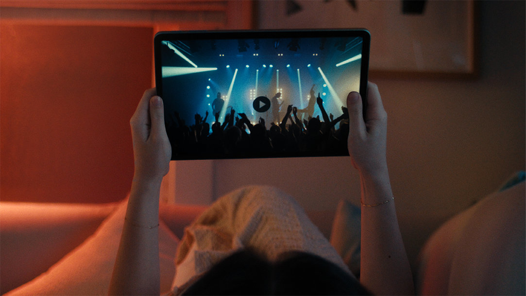 A Gen-Z enjoying a concert on their Surface Pro in tablet mode
