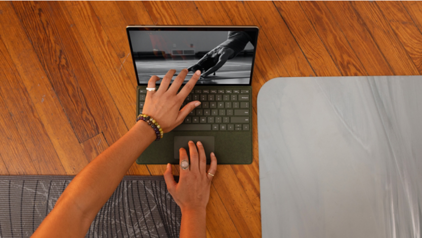 A Surface laptop on a wood floor
