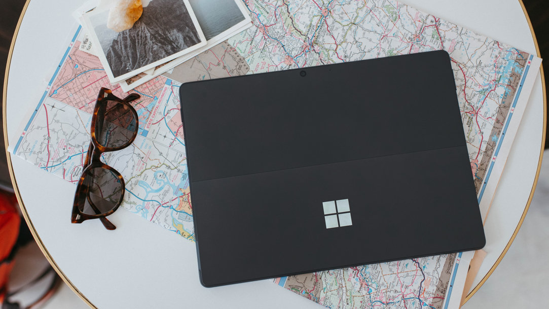 https://cdn-dynmedia-1.microsoft.com/is/image/microsoftcorp/MSFT-A-Surface-laptop-with-a-map-and-other-travel-items?scl=1