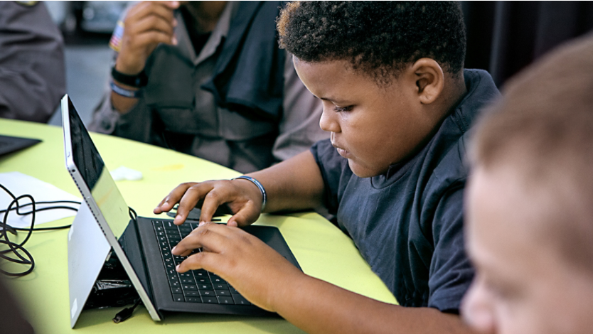 A boy typing on a Surface device