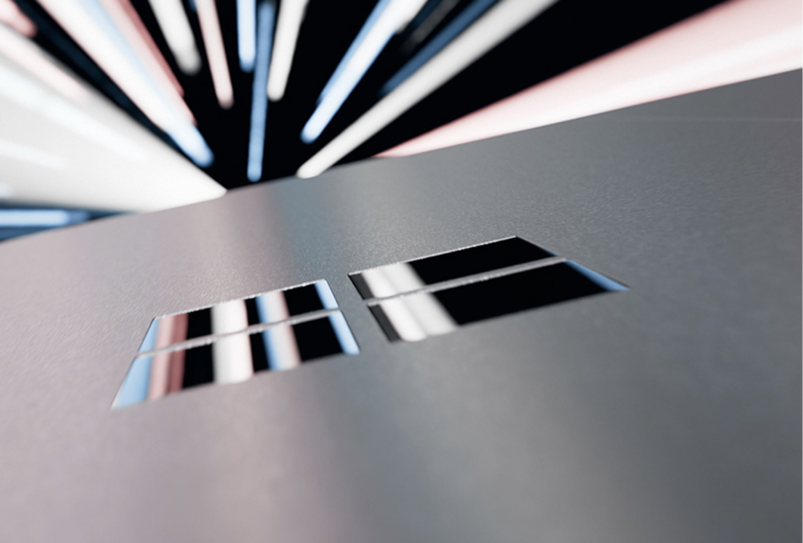 Een close-up, abstract beeld van een Surface-apparaat dat door lichtstralen beweegt