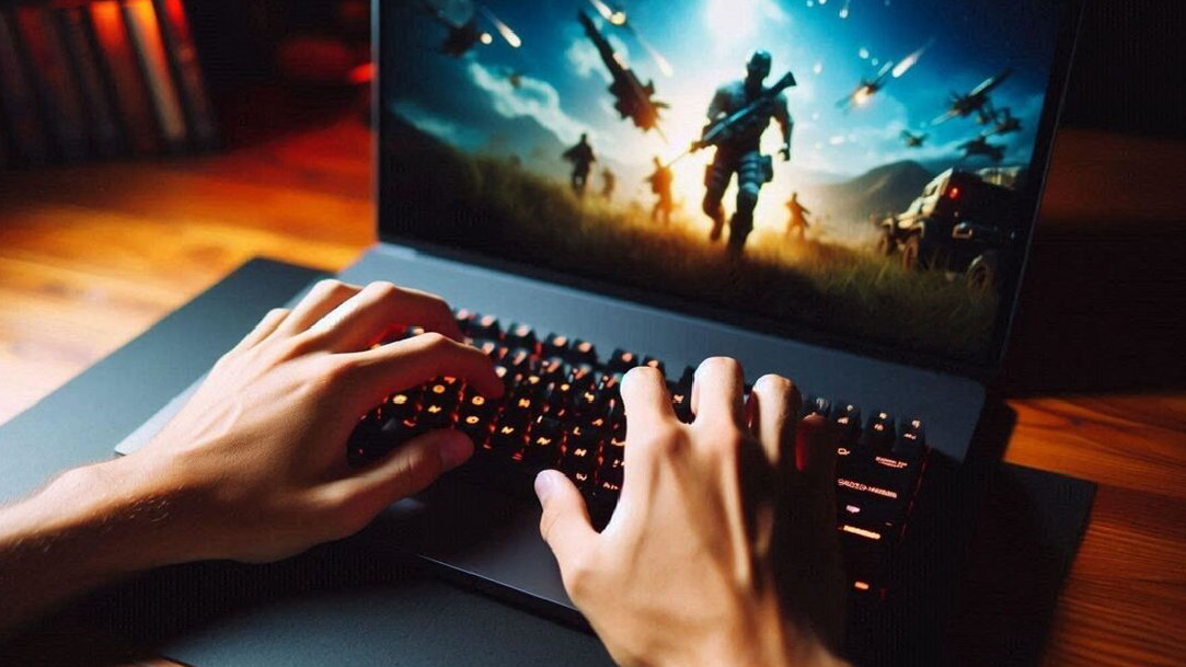 A close-up of a person’s hands on the keyboard of a gaming computer