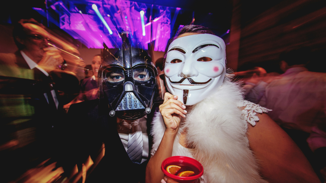 A couple wearing Halloween costumes at a party