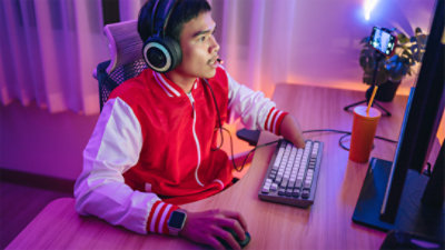 A disabled male gamer explores Windows accessibility features in a neon-lit room