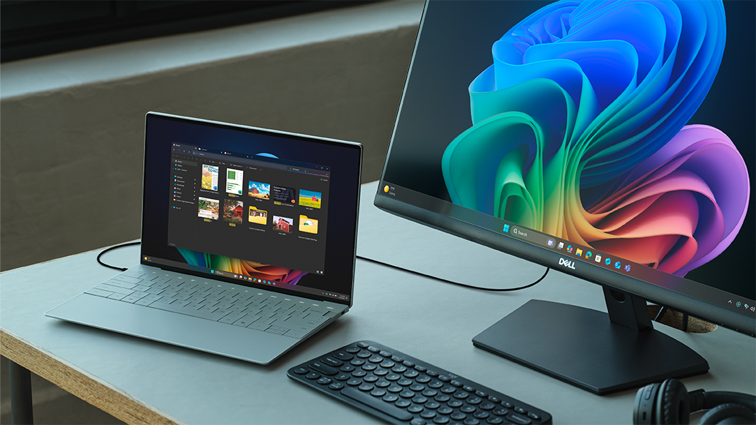 A dual monitor setup with a laptop, keyboard, headphones, and mouse on a desk