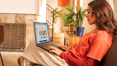 A female student on a couch with a Copilot+ PC