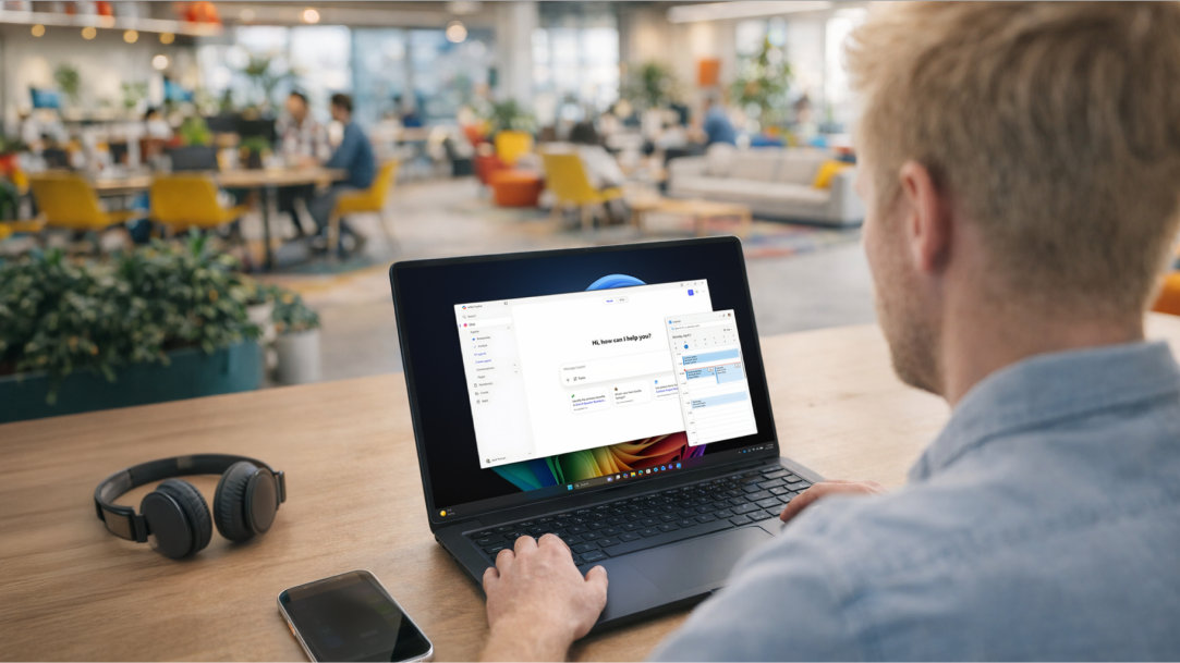 A man in a public setting uses multiple Windows apps to get things done