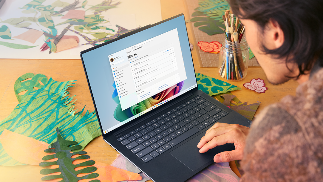A man in a studio checks tech specs on his PC
