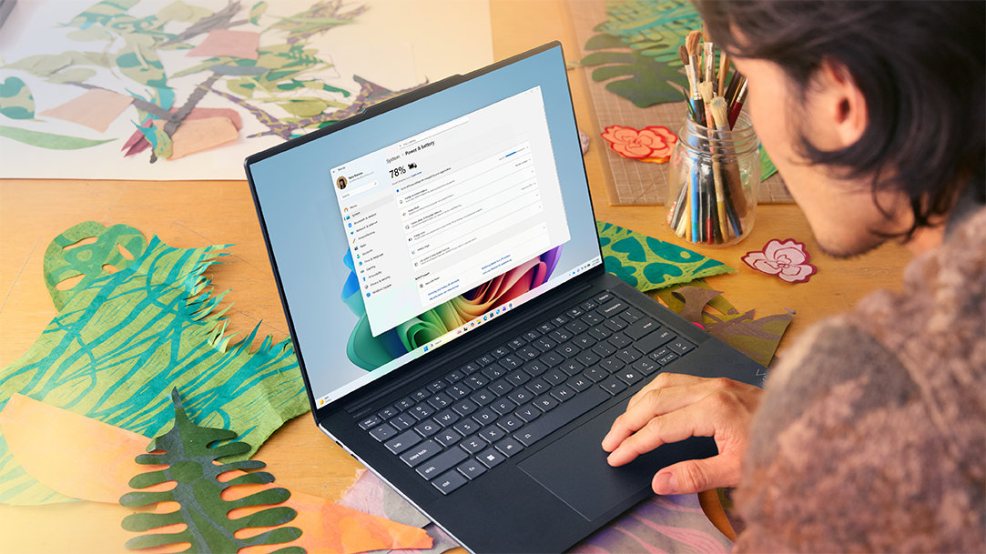 A man in a studio checks tech specs on his PC