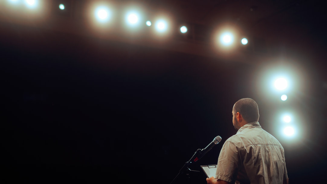 A man standing at a podium in an auditorium