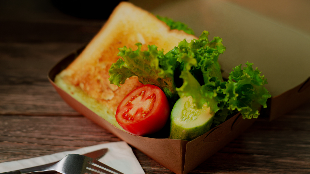 A nutritious lunch in a craft paper box on a table