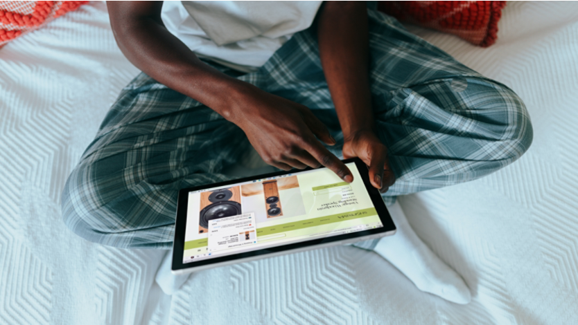 A person looking at photos in Microsoft Edge on a 2-in-1 PC