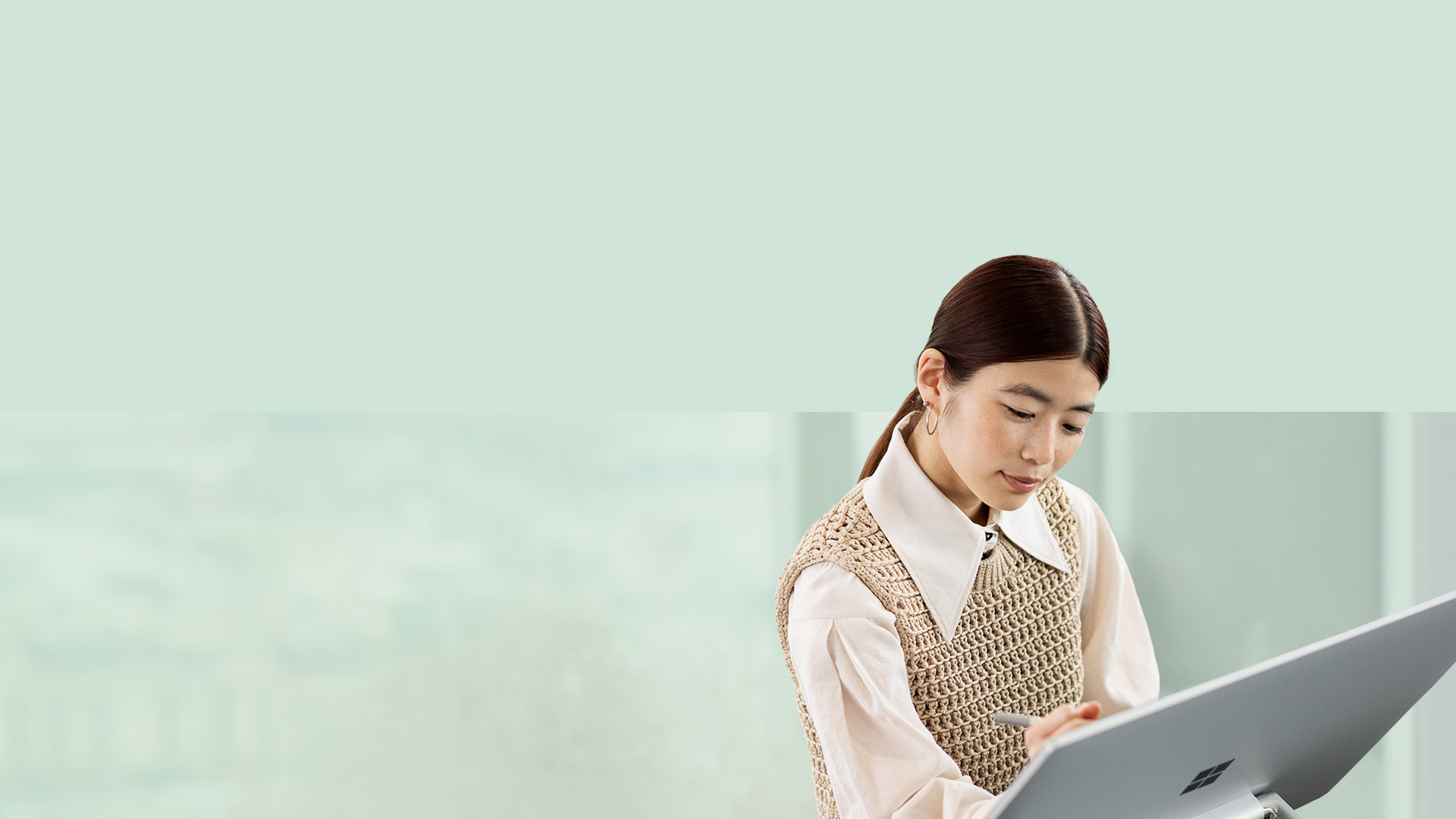 A person is seen using Surface pen to write on the surface of Surface Studio 2+