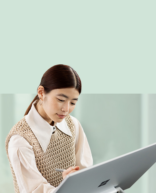 A person is seen using Surface pen to write on the surface of Surface Studio 2+