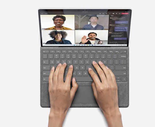 A person typing while using Teams on Surface Pro X.