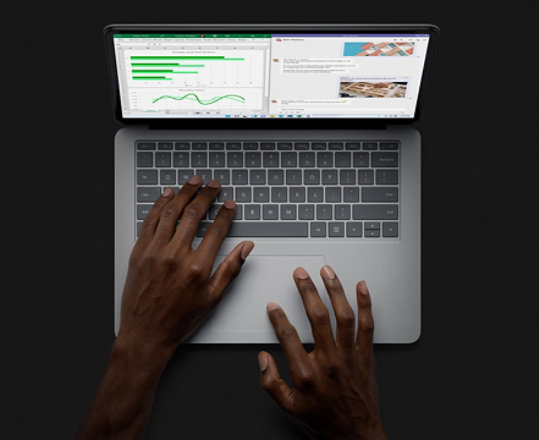 A person uses Surface Laptop Studio in laptop mode.