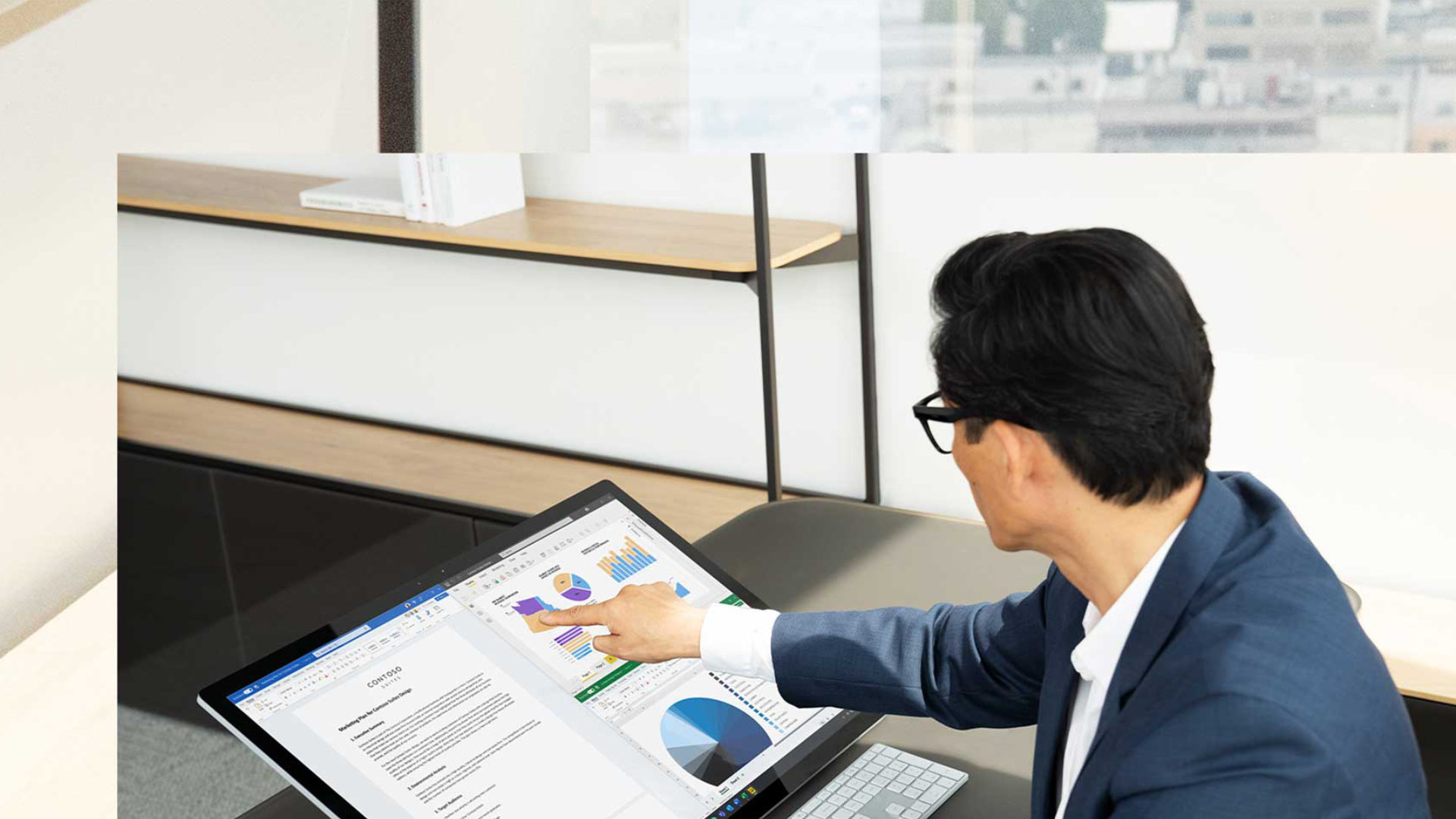 A person uses the touchscreen to interact with their Surface Studio 2+ device