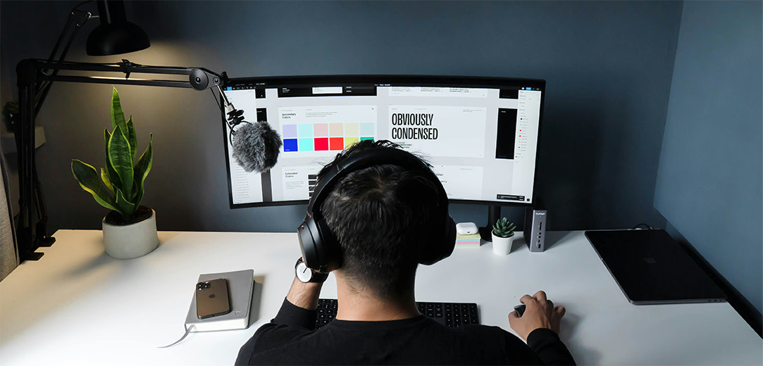 A person using AI for job searching and working on their graphic design side hustle on a computer