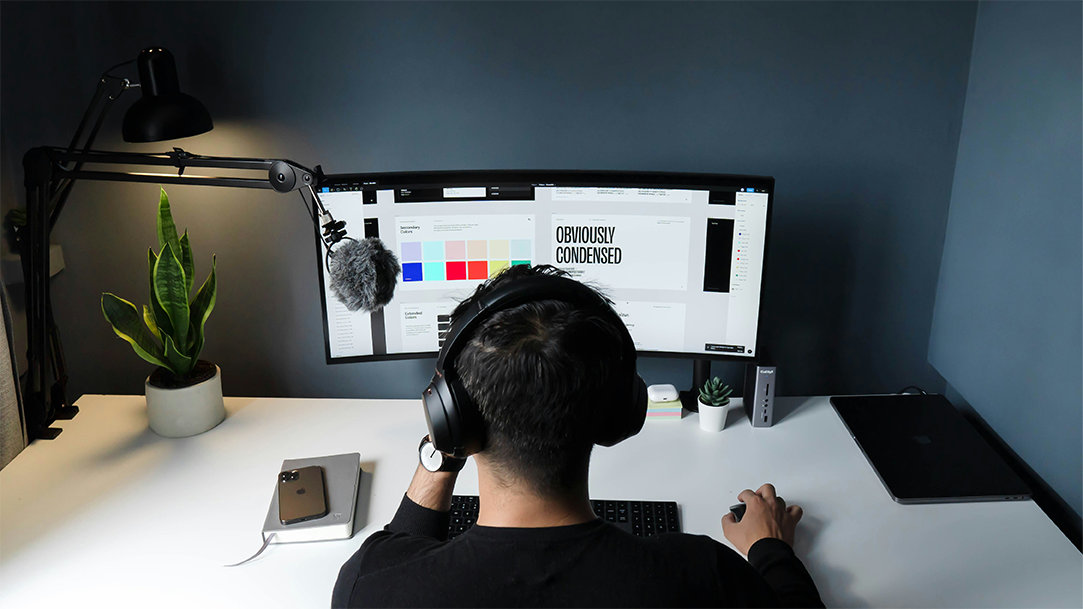 A person using AI for job searching and working on their graphic design side hustle on a computer