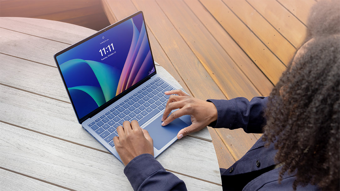 A person using a Surface Laptop Copilot+ PC in Sapphire to prep for back to school
