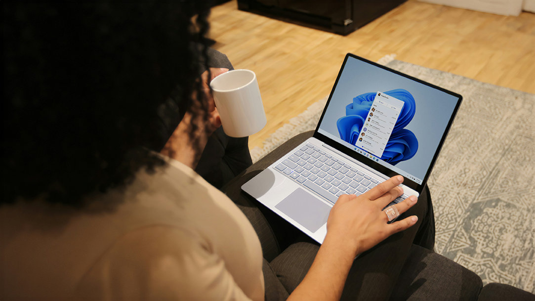 A person using her Windows AI assistant to do work on her Windows Laptop