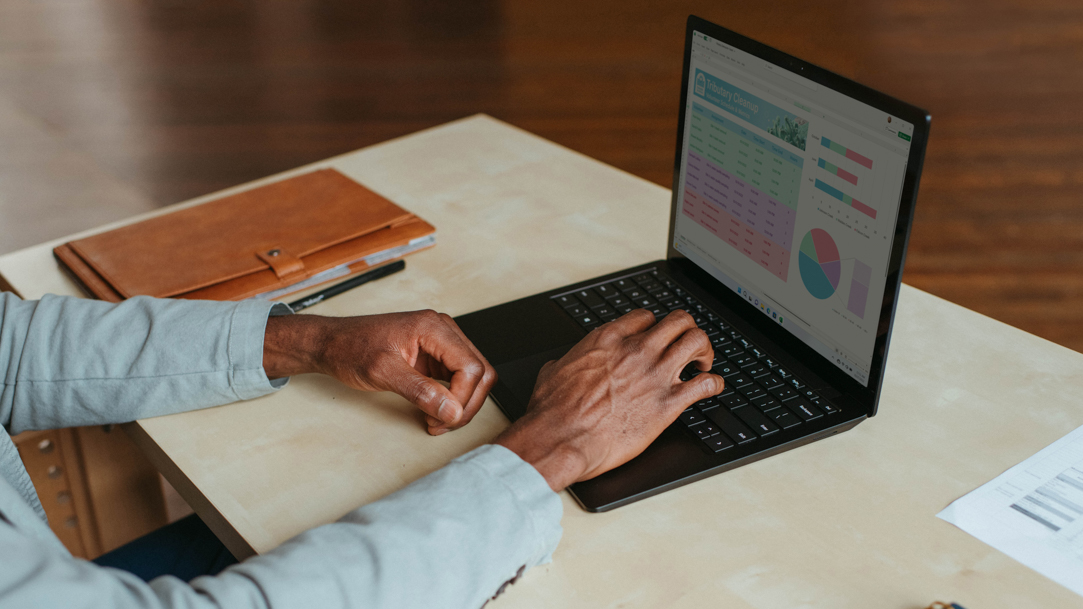 A person with a laptop on a desk uses Microsoft Edge browser to find their IP address