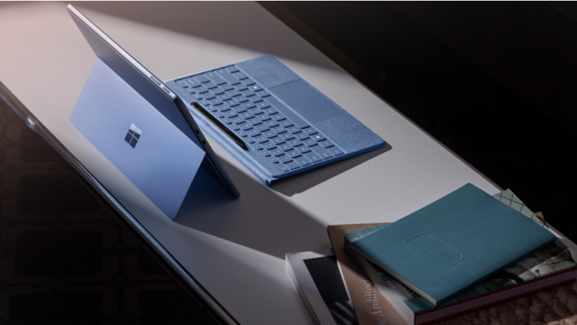 A sapphire Surface Pro 11ᵗʰ Edition and detached Surface Pro Flex Keyboard with a Surface Slim Pen in its digital pen holder