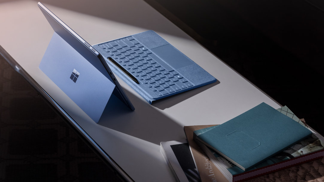 A sapphire Surface Pro 11th Edition and detached Surface Pro Flex Keyboard with a Surface Slim Pen in its digital pen holder