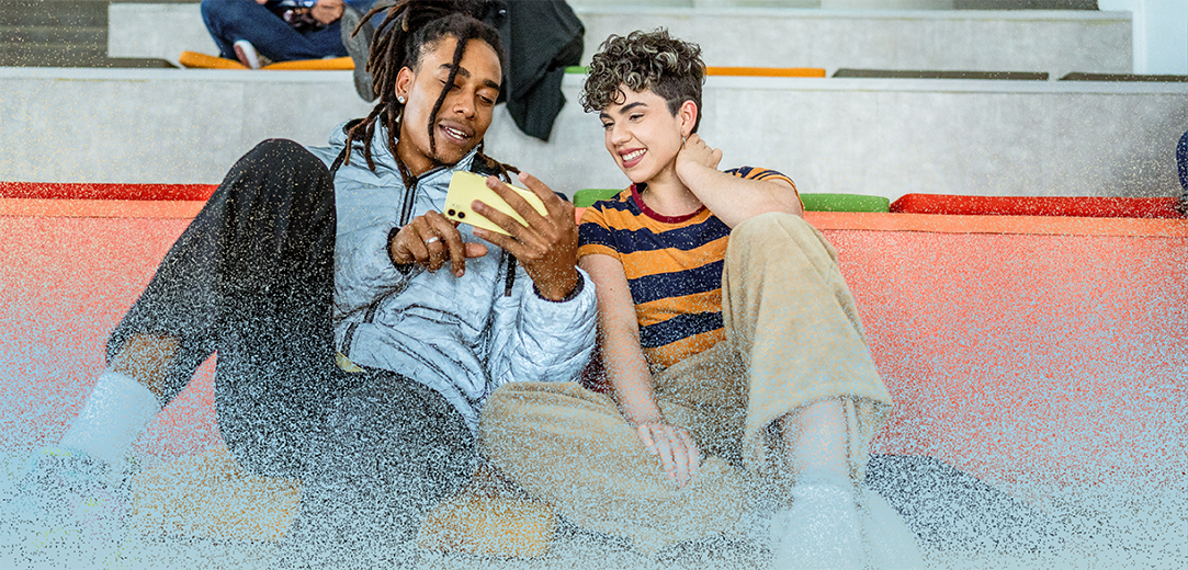 Young students friends talking and using mobile phone at auditorium