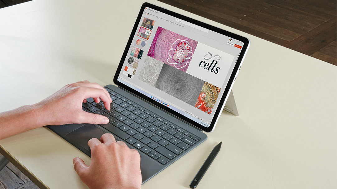 A student with a Surface Pro 12" Platinum device in laptop mode and the kickstand extended