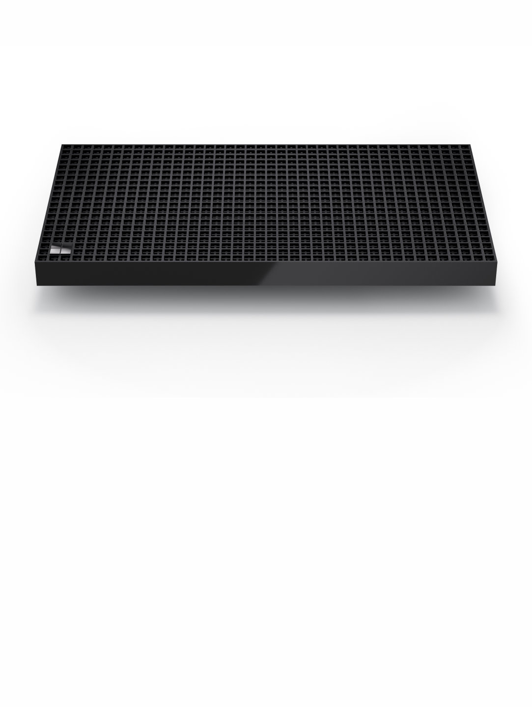 Black rectangular device with perforated top surface, shown at an angle on a light background
