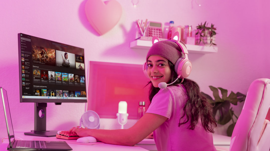 A teenage female gaming on her Windows 11 desktop and laptop