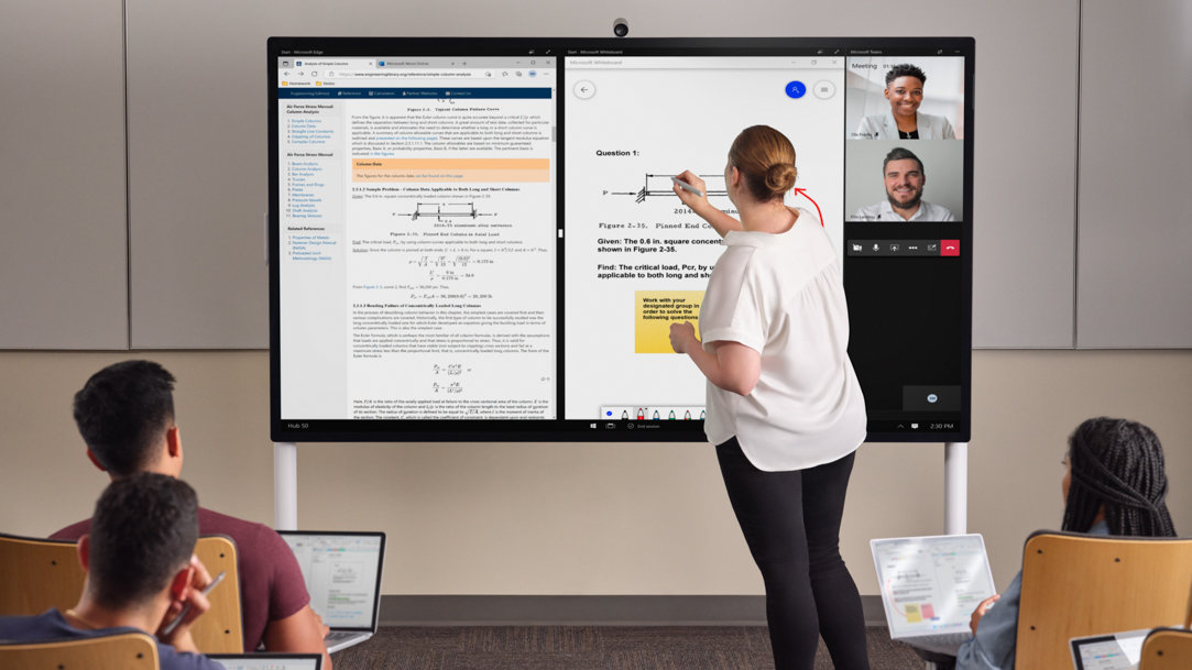 A woman giving a presentation in front of a large screen