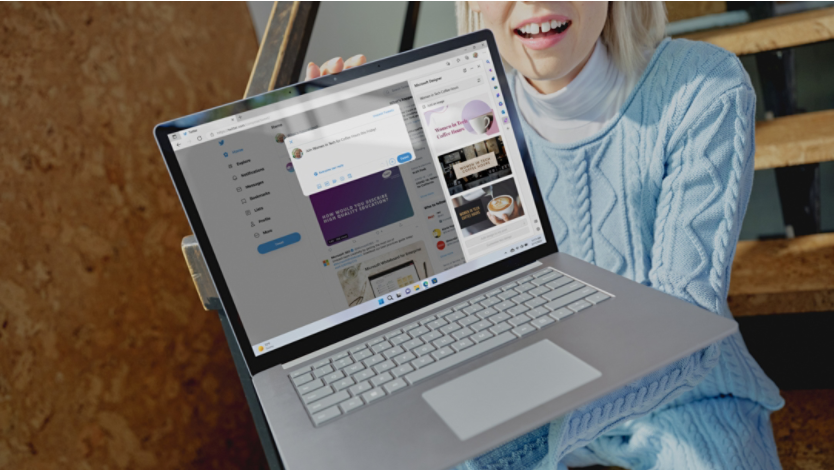 A woman holding Surface device displaying social media feed