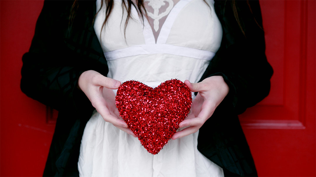 A woman holding a crafted Valentine’s heart