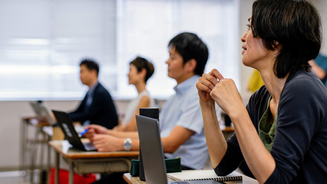 A woman in a graduate class considering AI to assist with her research