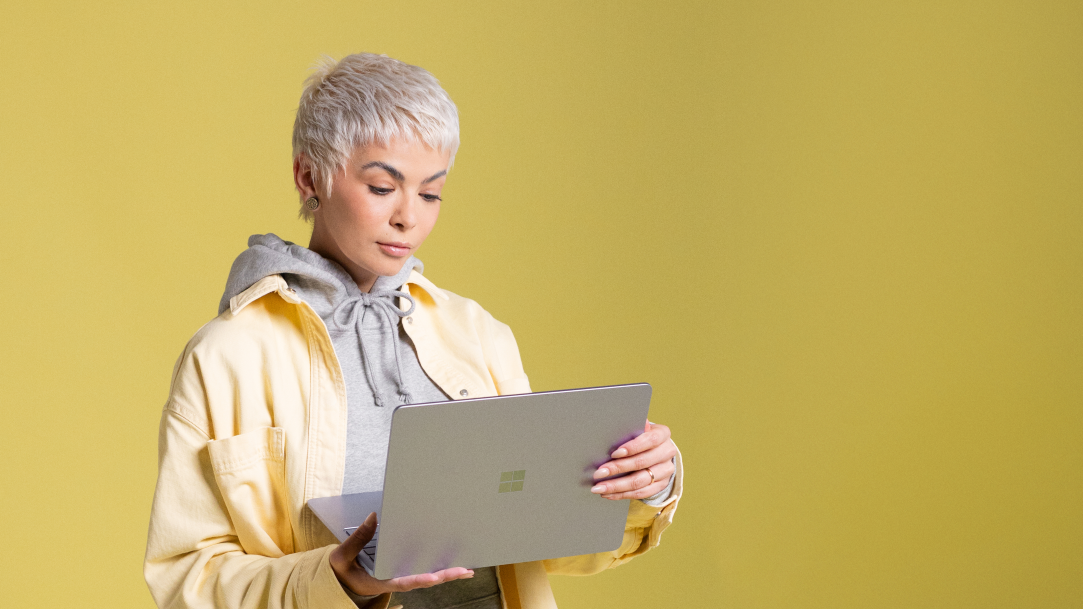 A woman using the MS Edge Browser on a Surface Laptop