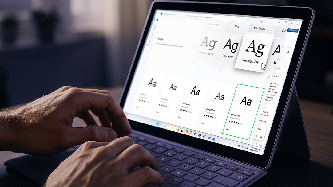 A young man on a Surface Pro laptop adding fonts