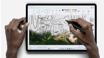 An artist uses a drawing software App on their PC tablet