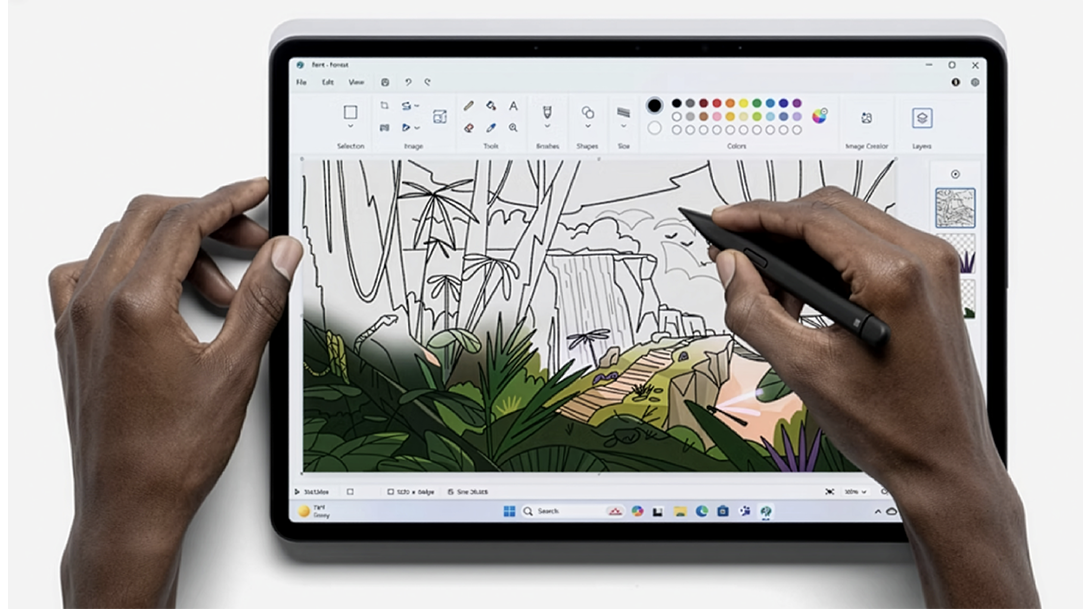 An artist uses a drawing software App on their PC tablet
