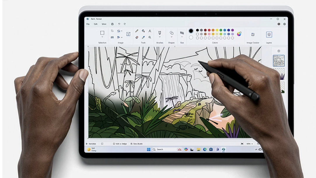 An artist uses a drawing software App on their PC tablet