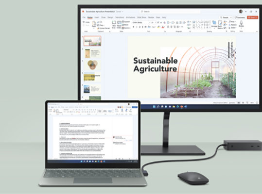 An external monitor sits behind a Surface Laptop Go 2 on an office desk