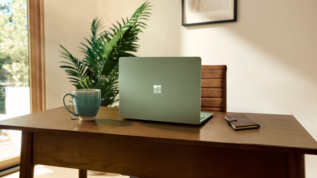 An image of a home office desk with a Surface Laptop on it