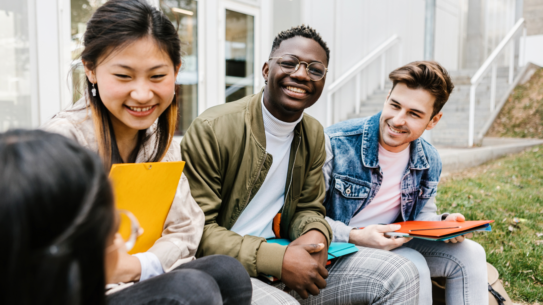 An image of a multiracial group of students hanging out at university campus