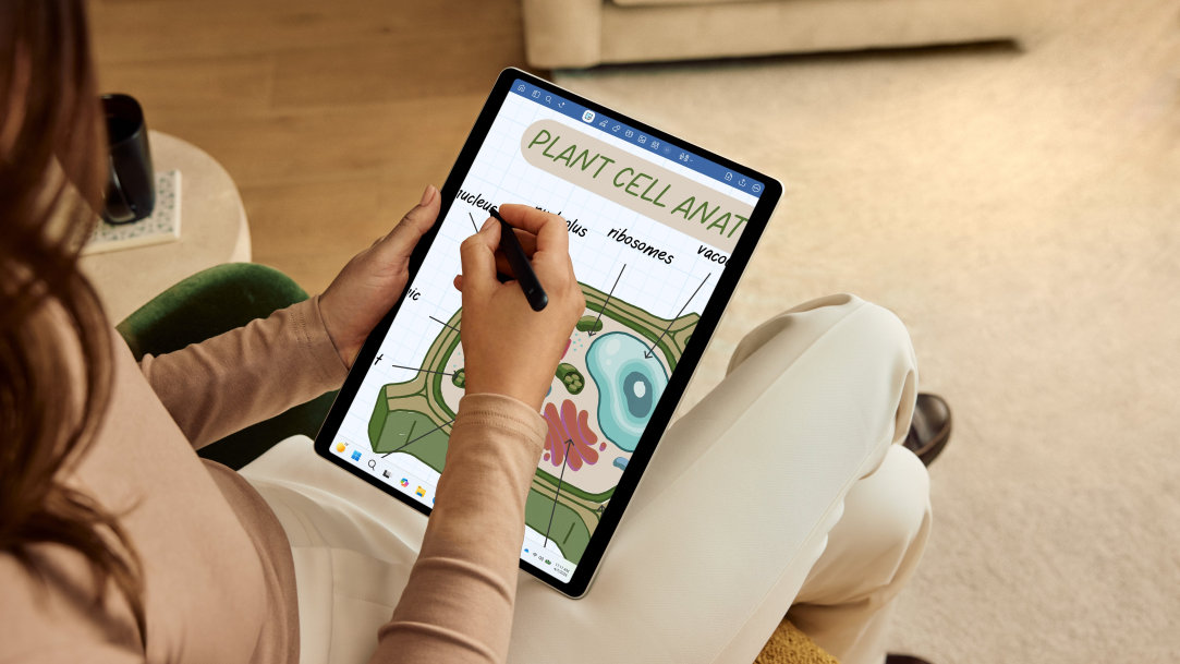 An image of a woman using a Surface Slim Pen on a Surface Pro, in tablet mode
