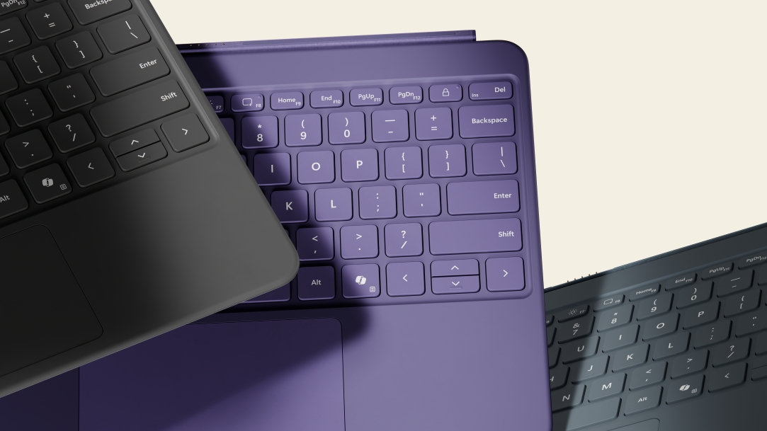 An image of three Pro Keyboards in Ocean, Violet, and Platinum