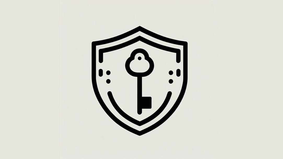 An outline in black of a shield with a key in the center